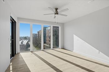 Room with ceiling fan and sliding glass doors1